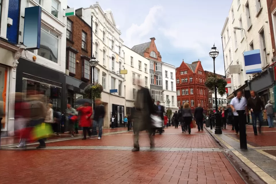 Pedewstrianized street paved with red bricks flanked by historic four-story buildings in Dublin, Ireland